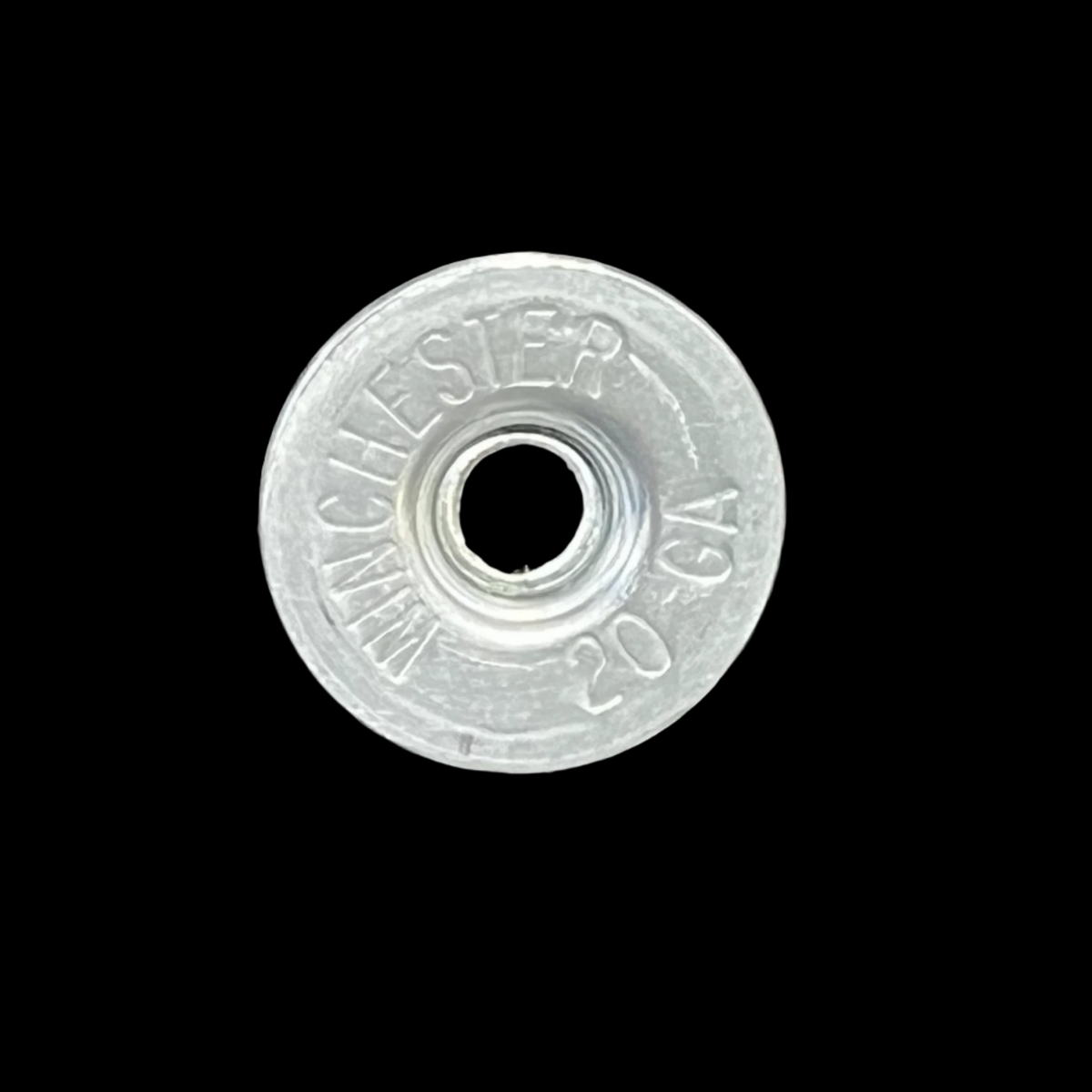 Silver Winchester 20 GA shotgun shell slice on a black background
