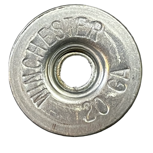 Close-up of a silver Winchester 20 GA deprimed shotgun shell slice on a white background