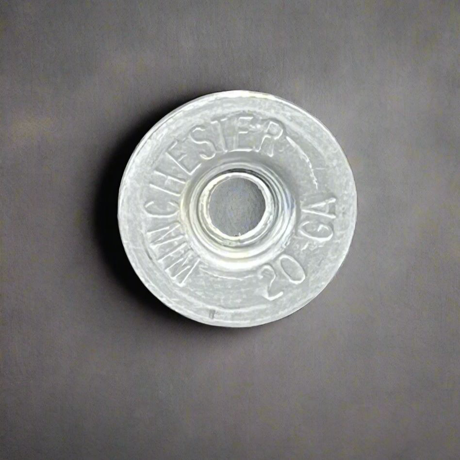 Silver Winchester 20 GA shotgun shell slice on a gray background