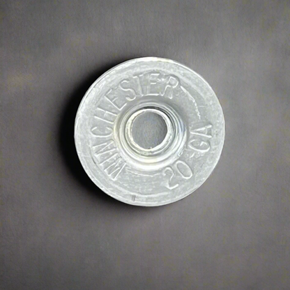 Silver Winchester 20 GA shotgun shell slice on a gray background