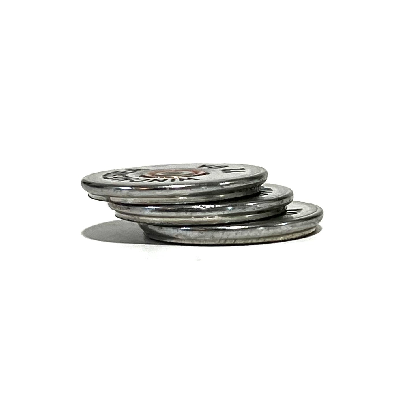 A stack of three silver, hand-painted bullet slices resting on a white background.