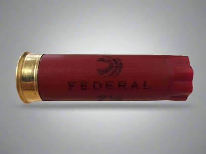 A single dark red Federal 12 gauge fired cartridge lying horizontally, ideal for crafting.
