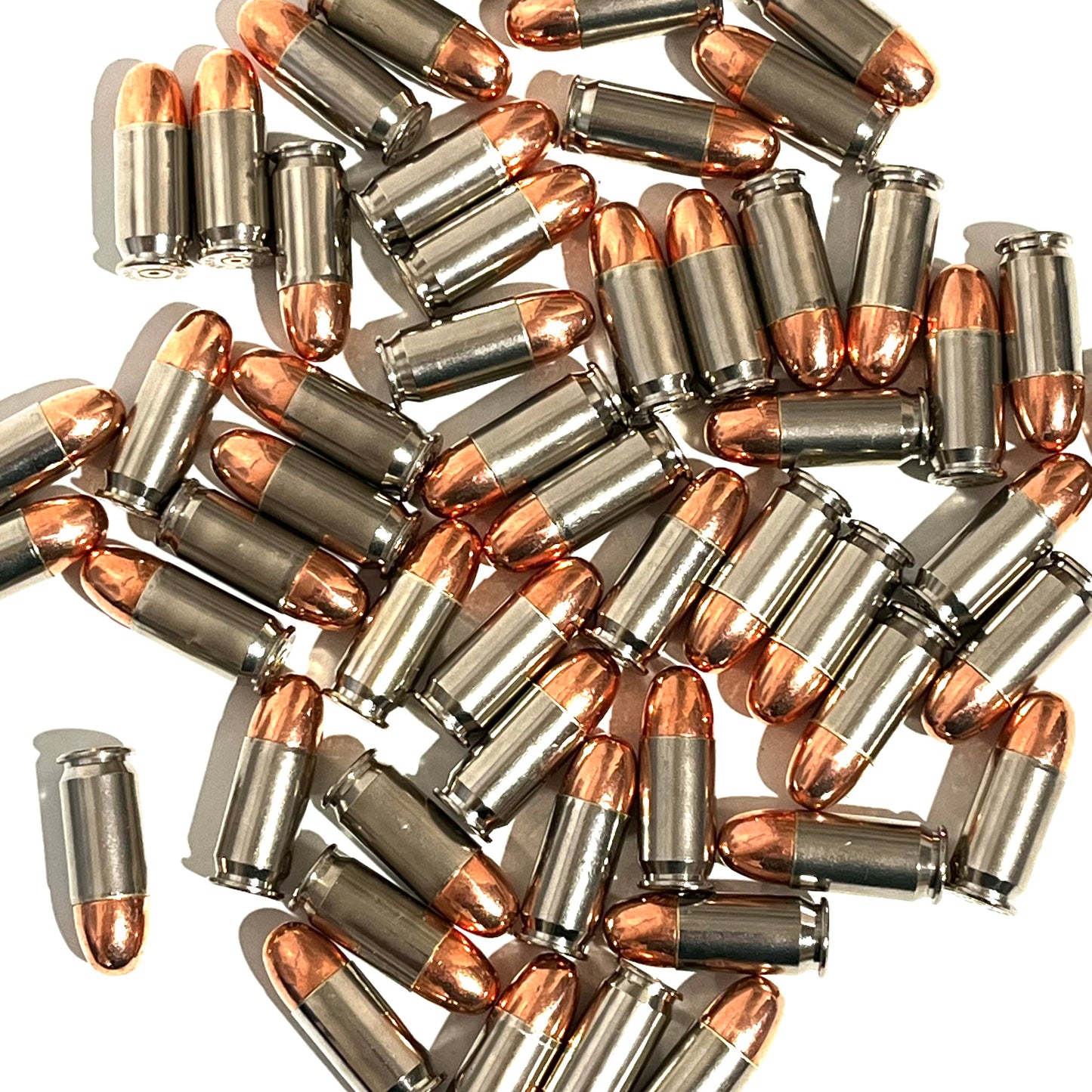 A scattered pile of nickel 45 ACP dummy rounds with copper round nose bullets on a white background.