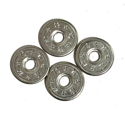 4 flattened silver 12 gauge shotgun shell slices arranged in a diamond pattern on white background, deprimed center holes