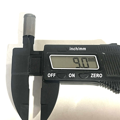 Digital caliper measuring the diameter of a steel 9mm casing at 9.0 millimeters