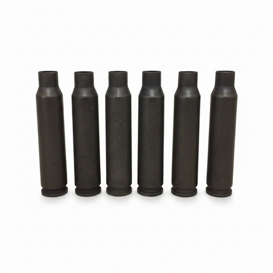 Seven dark gray steel .223/5.56 empty casings standing in a row with a QTY 10 overlay