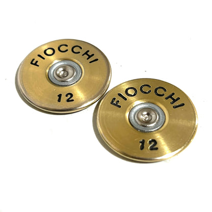 Two gold Fiocchi 12 gauge shotgun shell slices side by side showing black hand-painted FIOCCHI 12 lettering