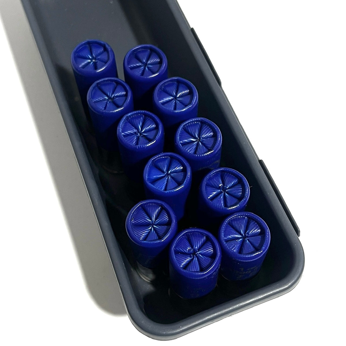 Fake blue shotgun shells 6 star crimp face up in a dark container
