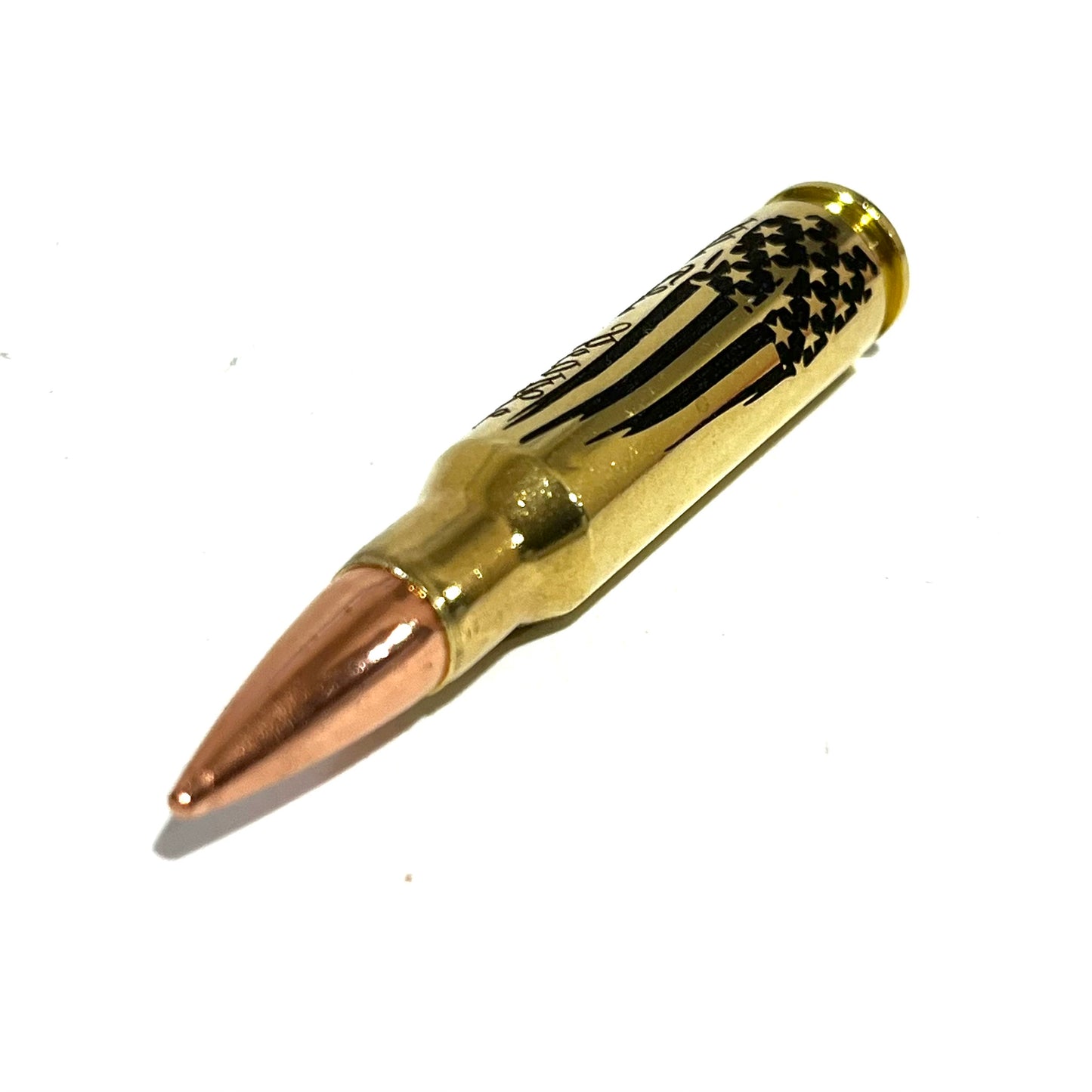 Close-up of a copper-tipped .308 bullet with 'We The People' engraving visible near the case neck