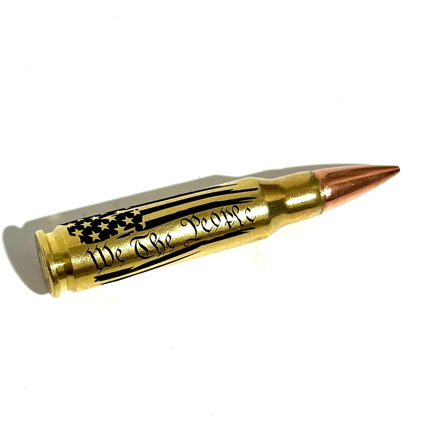 Engraved brass .308 cartridge with 'We The People' flag design, shown isolated on a white background