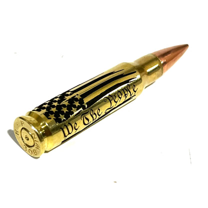 Brass .308 round with 'We The People' engraving, showing legible 'R-P 308 WIN' headstamp markings