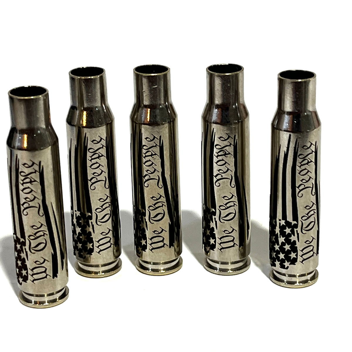 5 nickel .308 WIN cartridges engraved with We The People and a star flag design, standing upright