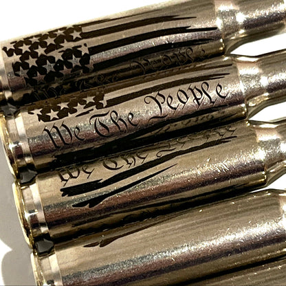 Close-up of We The People engraving and a star flag design on nickel .308 WIN cartridges