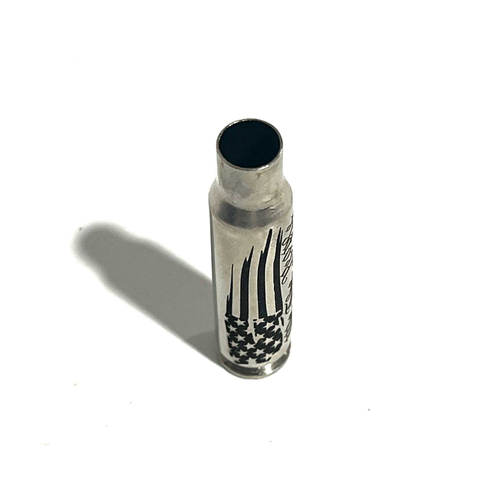 Nickel .308 WIN cartridge engraved with a star flag design, standing on a white background