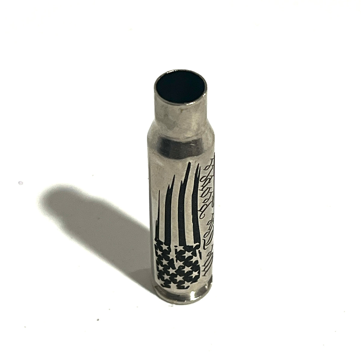 Nickel .308 WIN cartridge engraved with a star flag design, standing on a white background