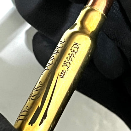 Close-up of a brass .308 WIN cartridge engraved with 'We The People' and a star-and-stripes flag design