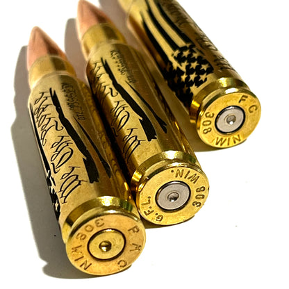 3 brass .308 WIN cartridges engraved with 'We The People Are Pissed' text, close-up