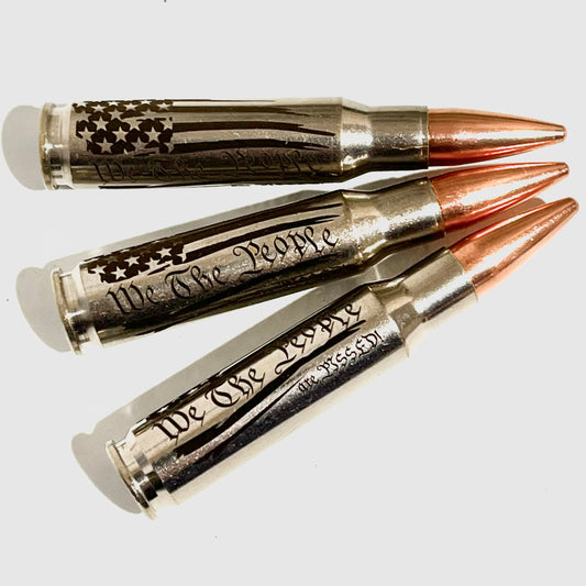 3 nickel .308 WIN cartridges with copper bullet tips engraved with an American flag and We The People Are Pissed lettering