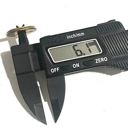A digital caliper measures the center hole of an empty gold slice, reading 6.1 mm.