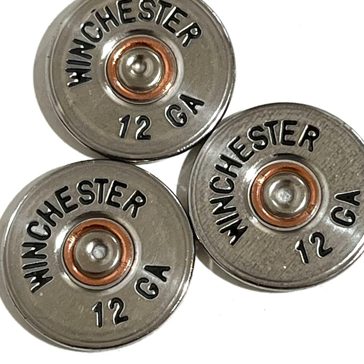 Three silver Winchester 12 gauge shotgun shell painted cut slices clustered together in close-up.