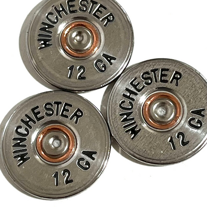 Three silver Winchester 12 gauge shotgun shell painted cut slices clustered together in close-up.