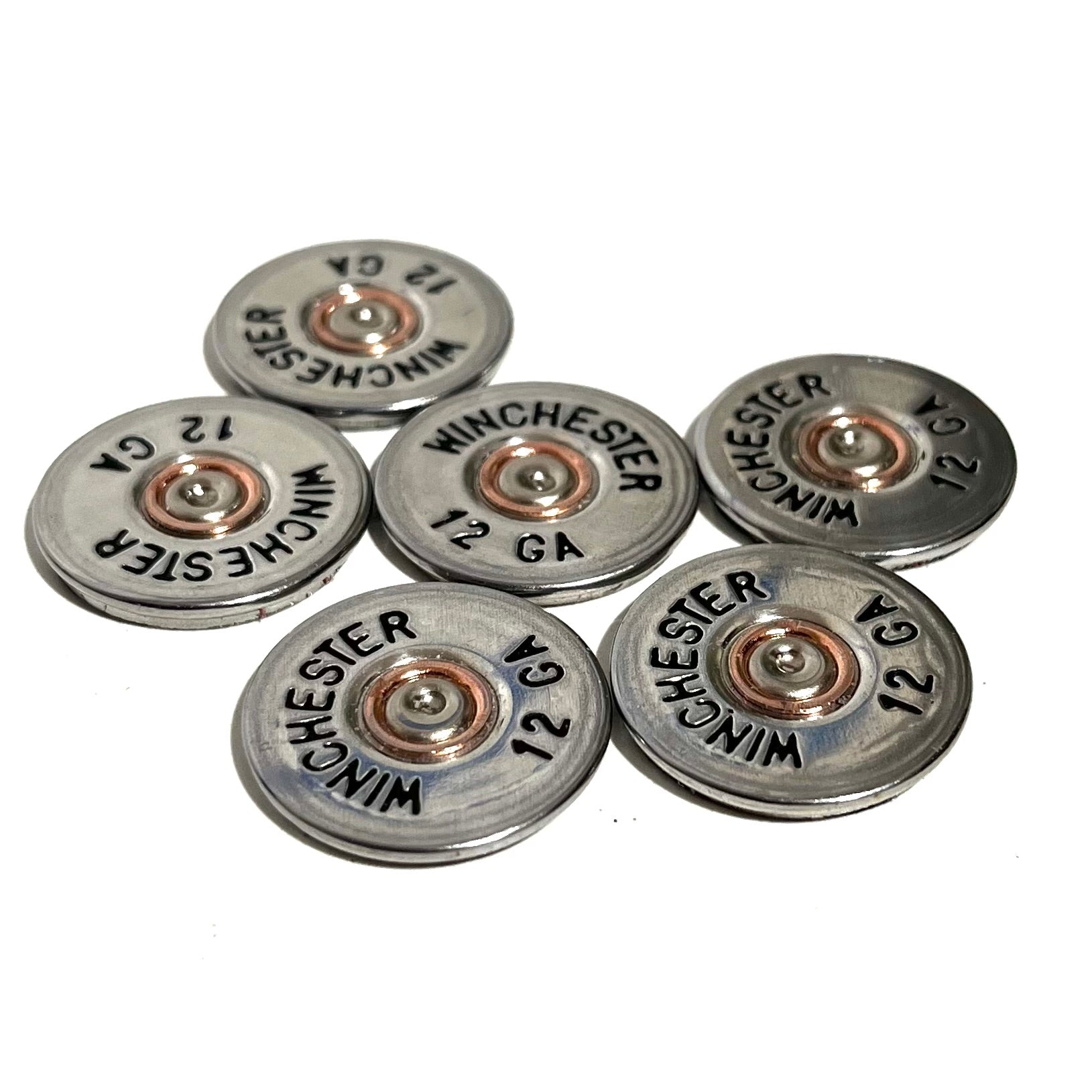 Six silver Winchester 12 gauge painted bullet slices arranged in a flat overhead cluster.