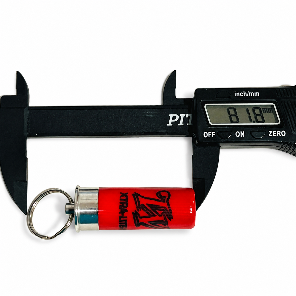 Digital caliper measuring a used red cartridge keychain at 81.8 mm overall length, ring included