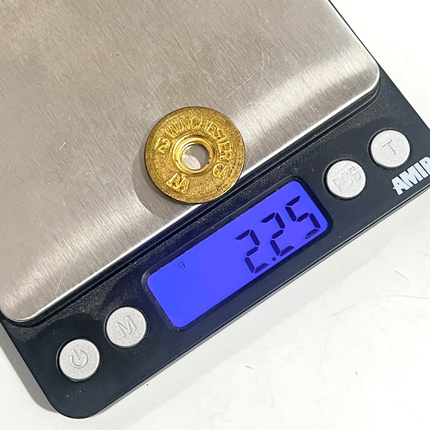 A gold once-fired slice rests on a digital scale, which displays a weight reading of 2.25 grams.