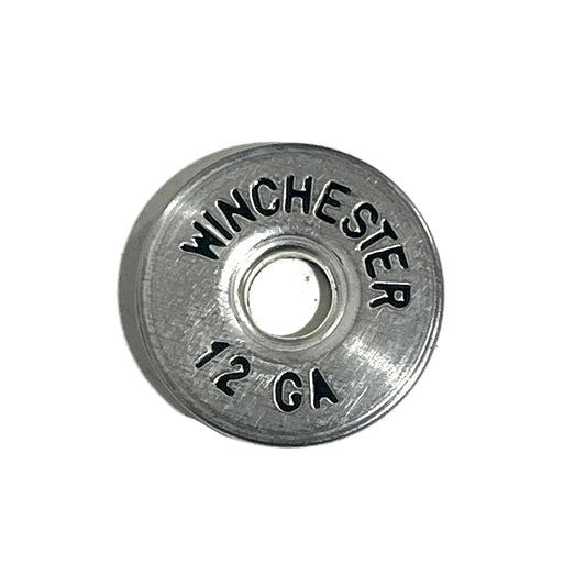 A single deprimed silver hand painted Winchester 12 gauge shotgun shell slice on a white background.
