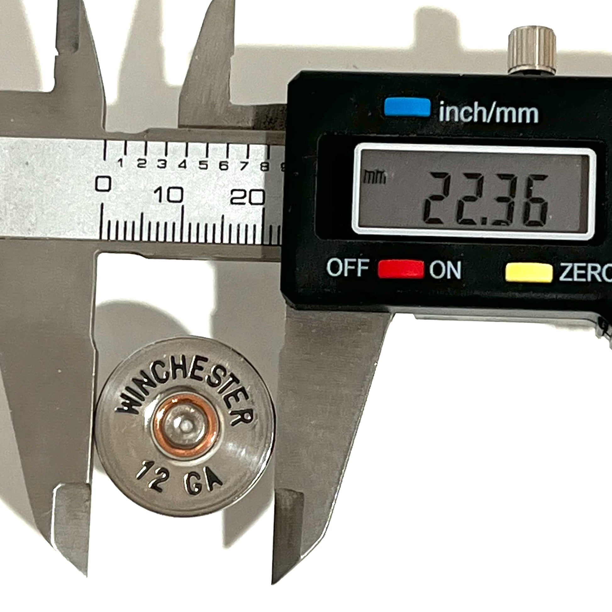 A Winchester hand painted 12 gauge shotgun shell slice measured for diameter with a digital caliper reading 22.36 mm.