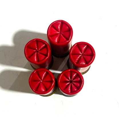 Direct overhead view of ten standing red Winchester Super X 12 gauge dummy rounds showing  a 6 star-crimped top mouths.