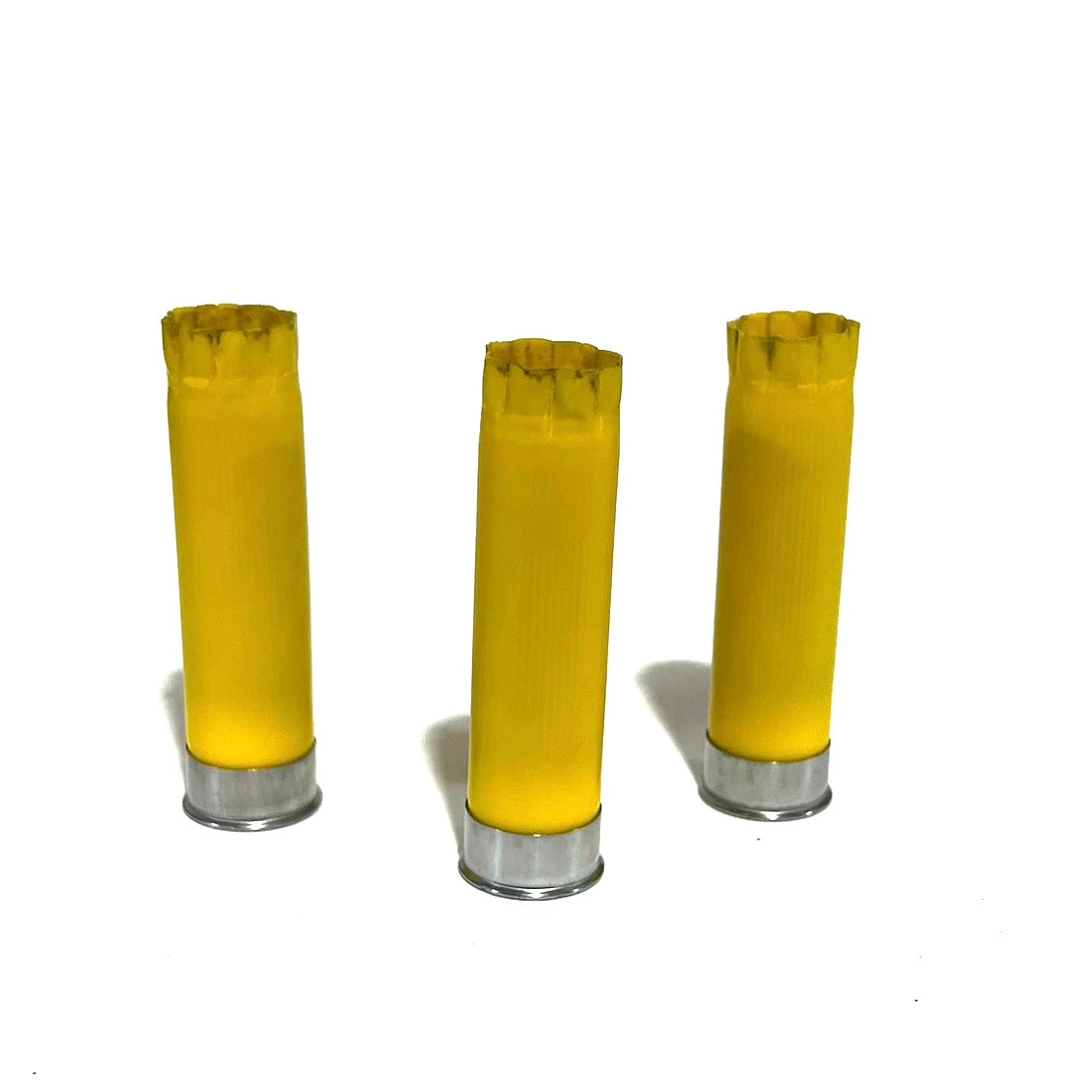 3 yellow shotgun shells with silver bases standing upright on a white background