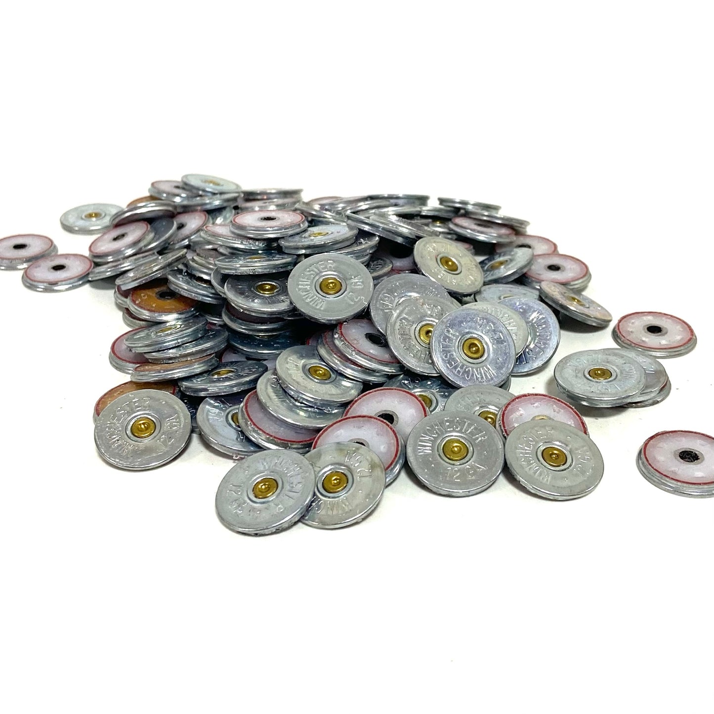 Large pile of silver Winchester 12 gauge shotgun shell slices with brass primers