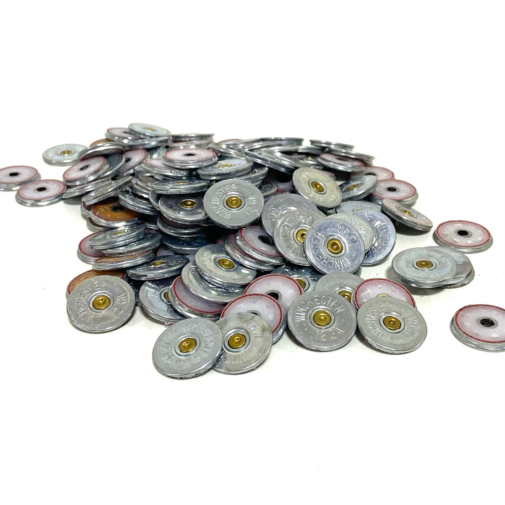 Large pile of silver Winchester 12 gauge shotgun shell slices with brass primers