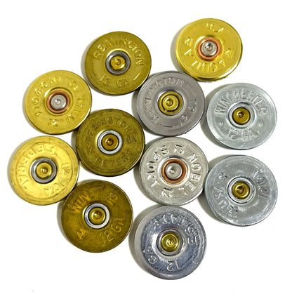 Ten 12 gauge shotgun shell slices arranged in a ring showing mixed gold and silver metallic bases.
