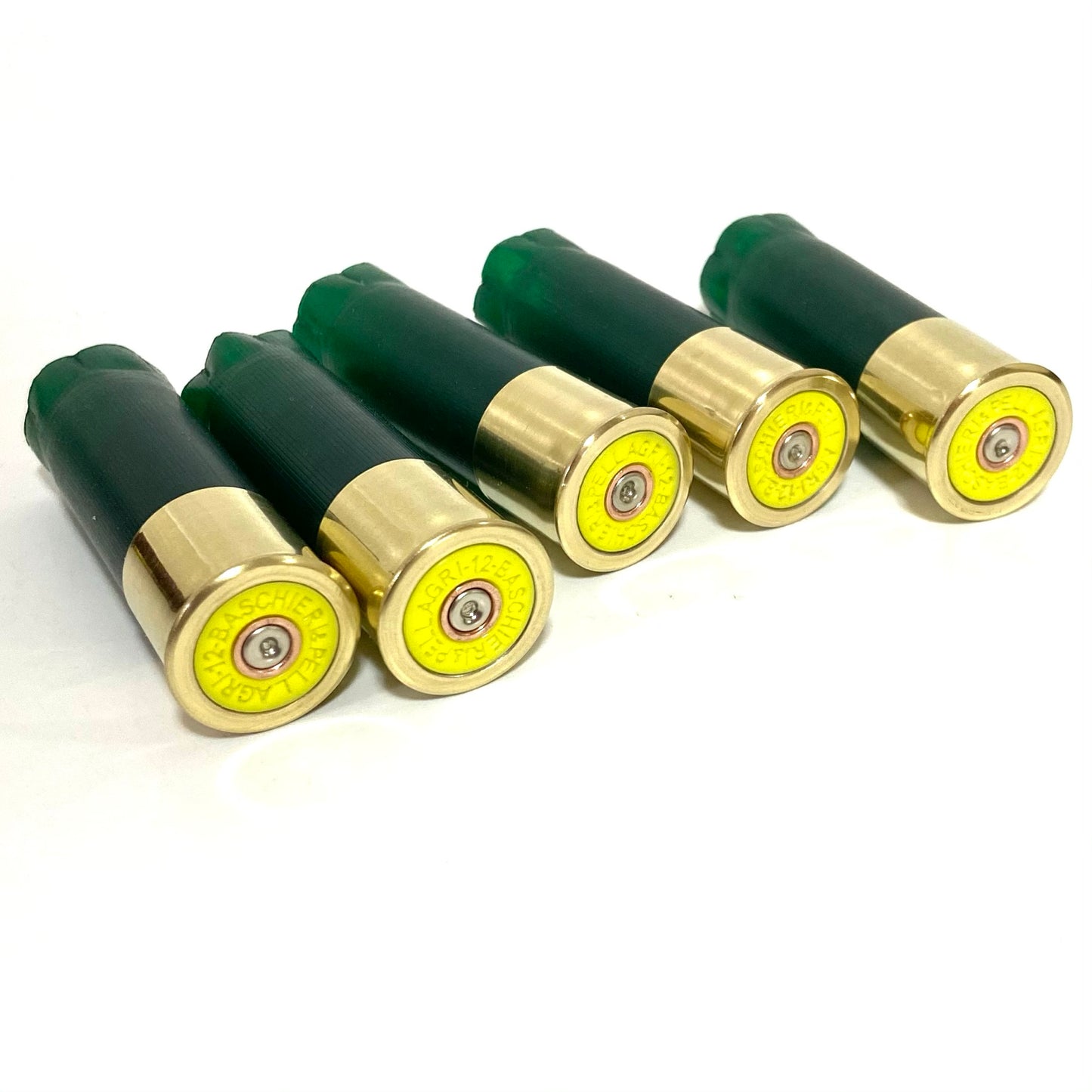 Five green 12 gauge shotshells in a diagonal row showing their gold brass bases with yellow inserts on a white background for boutonnieres.