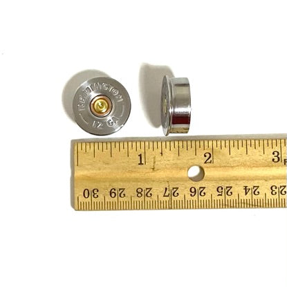 Two silver 12 gauge brass end caps beside a wooden ruler showing flat base face and side profile for size reference.