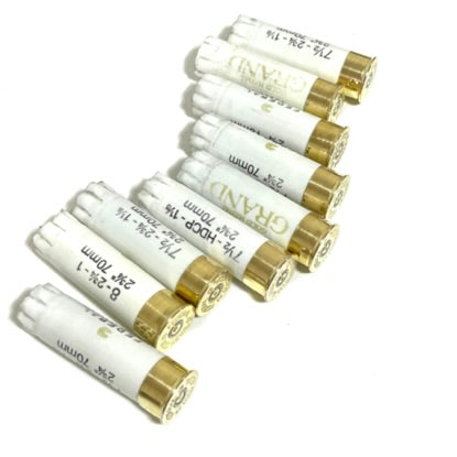 Five white 12ga empty shells with gold brass bases arranged diagonally on a white background.