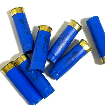 A pile of blue Federal empty shotgun shells scattered on a white background for crafting.