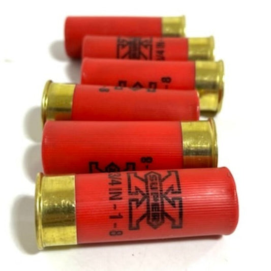 Five red 12 gauge Winchester Super X dummy rounds with brass metal bases stacked horizontally on a white background.