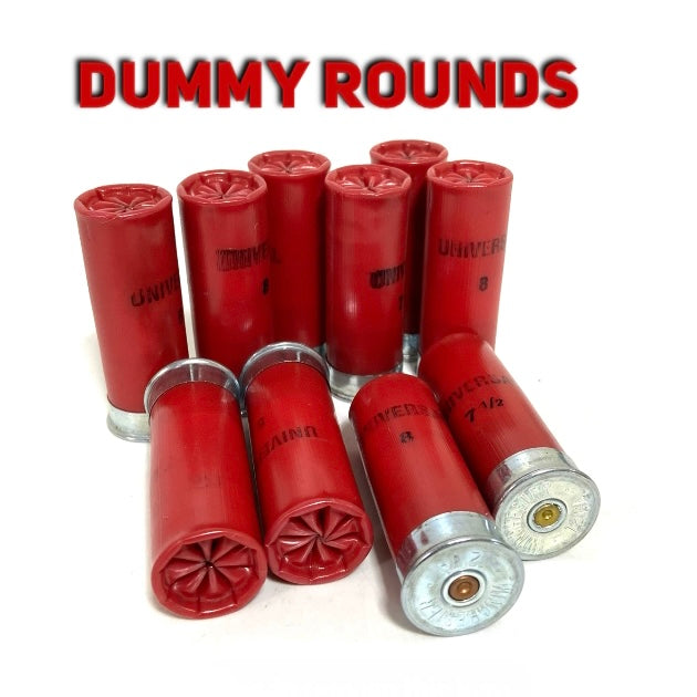 Nine red 12 gauge dummy rounds with silver bases on a white background beneath red overlay text reading DUMMY ROUNDS.