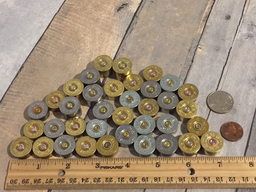 Close-up showing smooth metallic edges of 20 gauge bottoms with penny, quarter, and ruler for reference.