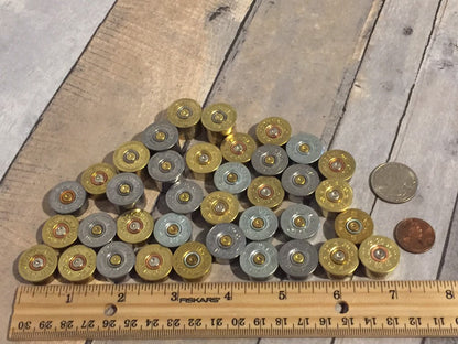 Close-up showing smooth metallic edges of 20 gauge bottoms with penny, quarter, and ruler for reference.