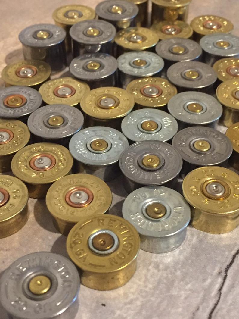 Close-up view of brass and nickel 20 gauge spent shell bases.