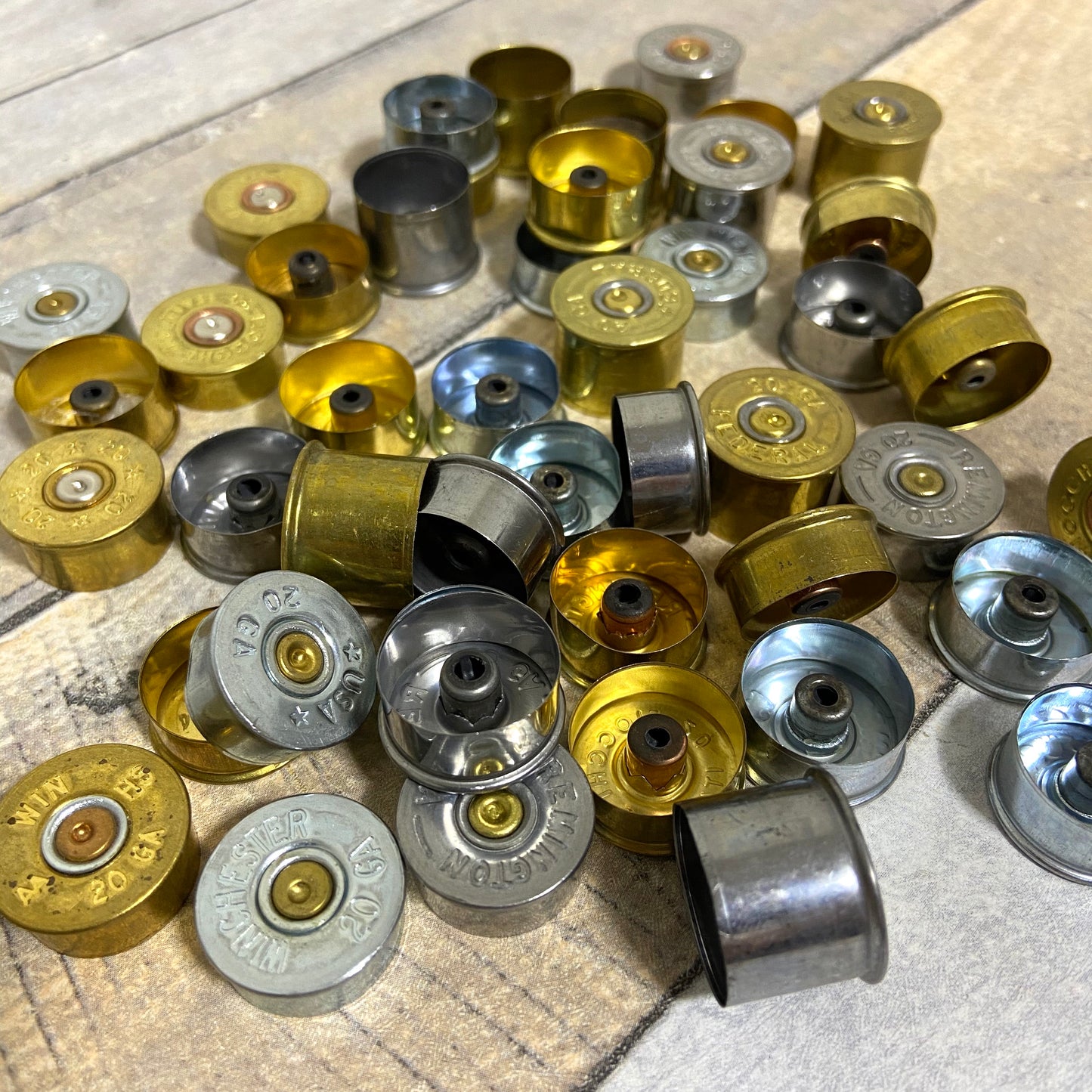 Group of 20 gauge metallic spent hull bottoms for craft projects.