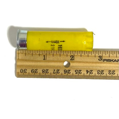 Herter's 20 gauge yellow shotgun shell shown next to a ruler for size reference