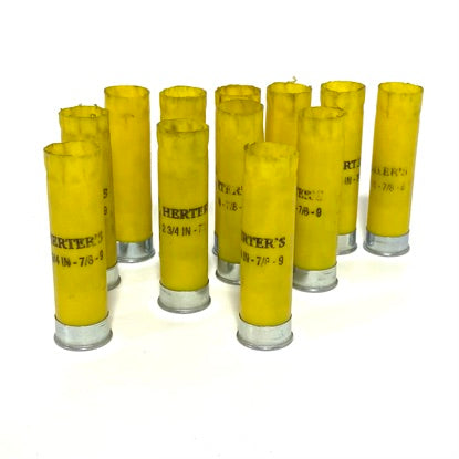 Standing group of Herter's 20 gauge yellow shotgun shell hulls