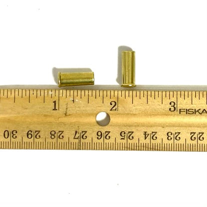Empty .22LR brass casing shown next to a ruler for size reference