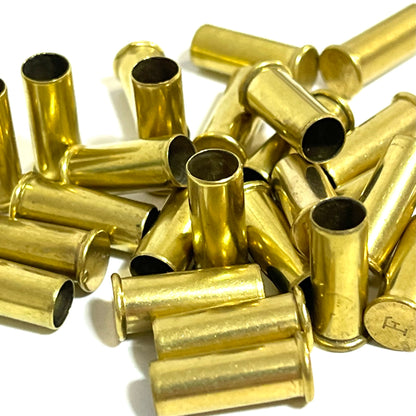 Close-up pile of empty .22LR brass casings with headstamps visible
