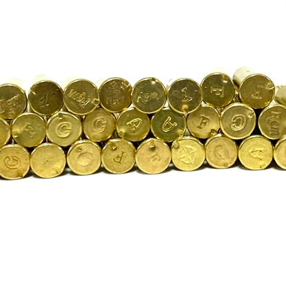 Close-up of mixed manufacturer headstamps on inert .22LR brass casings